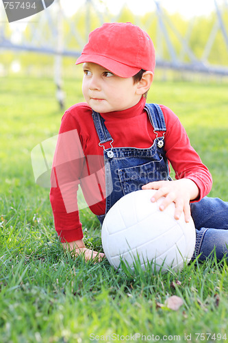 Image of Kid sitting with ball
