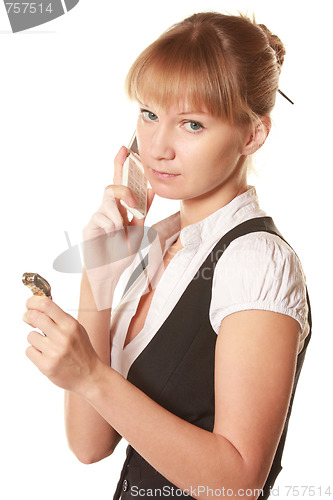 Image of Serious woman with phone and watch