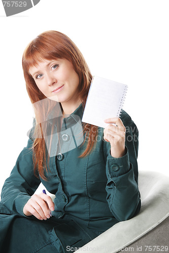 Image of Redhead in chair showing notepad