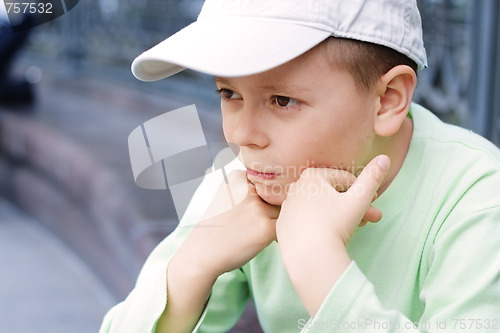 Image of Pensive boy in green