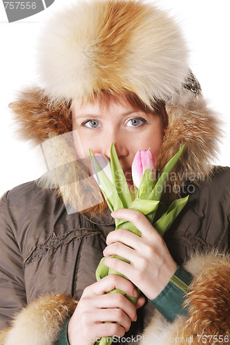 Image of Redhead in warm clothes with tulips