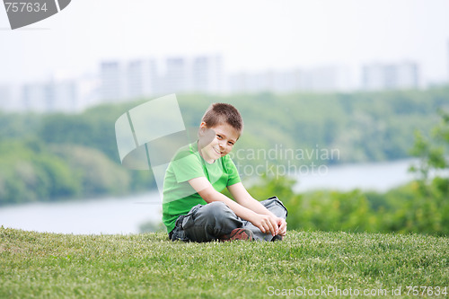 Image of Smiling boy in casual on grass