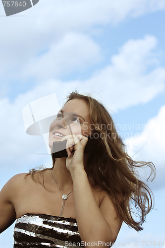 Image of Fair-haired girl over cloudscape with phone