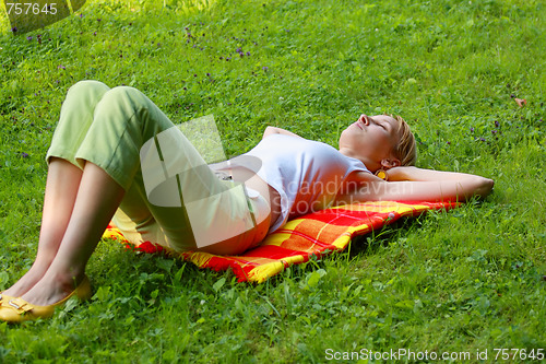 Image of Blonde sleeping in meadow