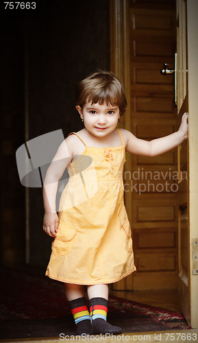 Image of Little girl at house door