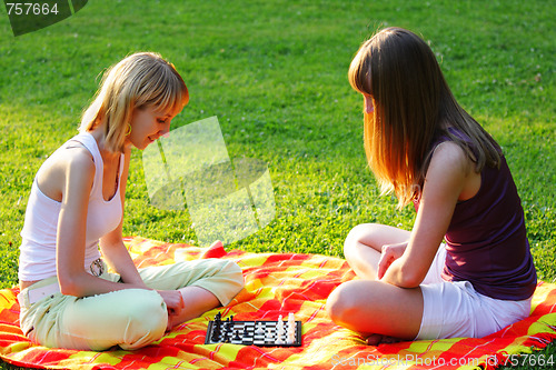 Image of Blond friends playing chess