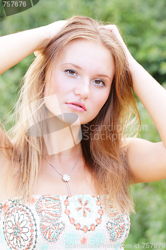 Image of Fairhaired woman hands over head