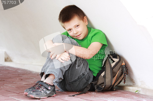 Image of Boy in green under wall