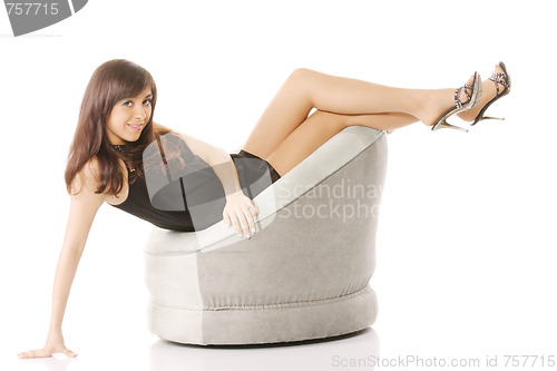 Image of Woman in chair with legs raised