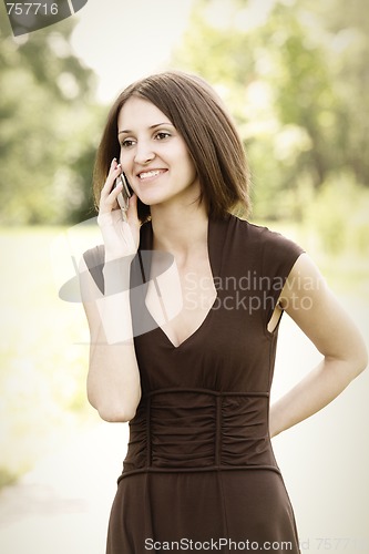 Image of Woman in brown with mobile