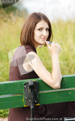 Image of Woman sitting on bench