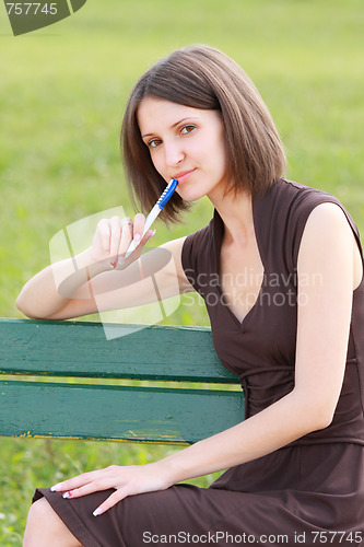 Image of Woman sitting on bench