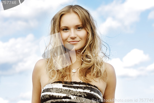 Image of Fair-haired girl over cloudscape