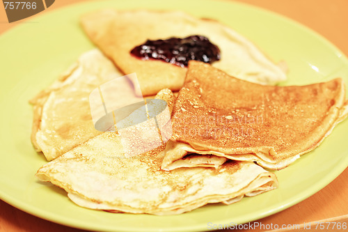Image of Pancakes with jam on green plate