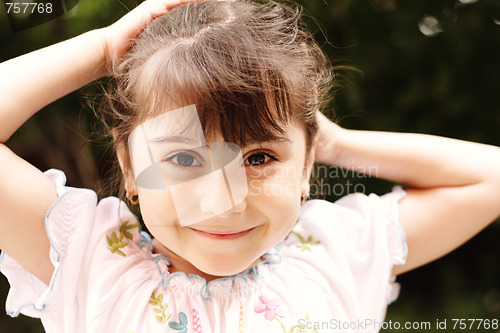 Image of Girl sleeking hairs
