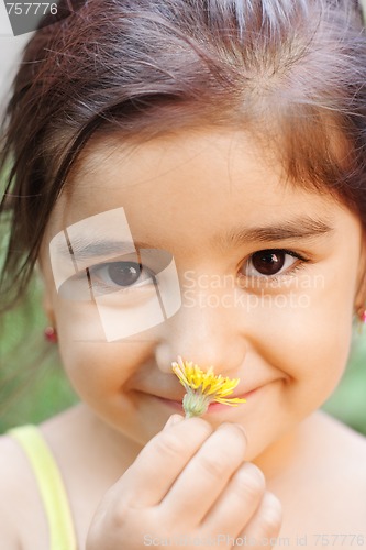Image of Girl smelling flower