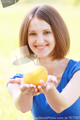 Image of Woman passing orange