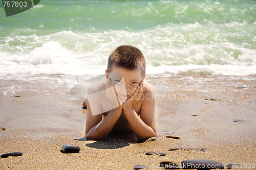 Image of Boy laying on beach