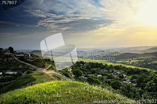 Image of Sun over mountain countryside
