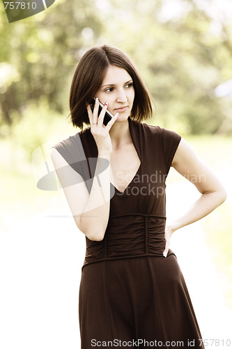 Image of Serious brunette listening phone