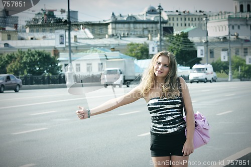 Image of Hitchhiking girl with pink bag