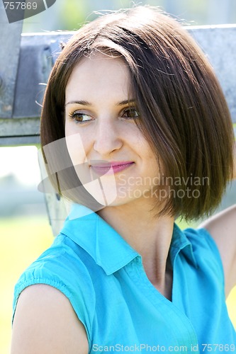 Image of Young woman in turquoise blouse