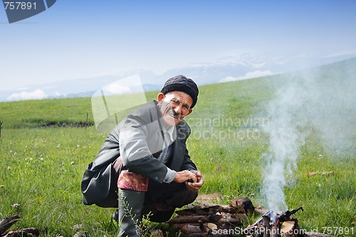 Image of Elderly man at campfire