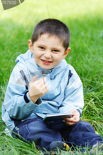 Image of Smiling boy with closed book