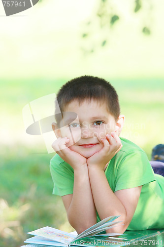 Image of Cute boy laying down on bench