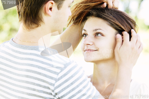 Image of Guy touching girlfriends hairs