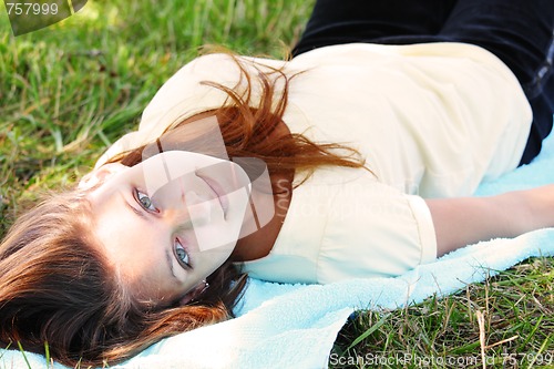 Image of Girl laying on blue towel