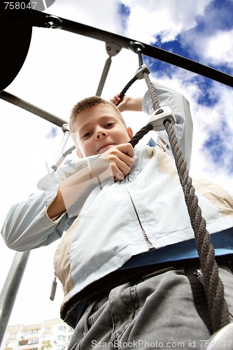 Image of Boy on rope ladder