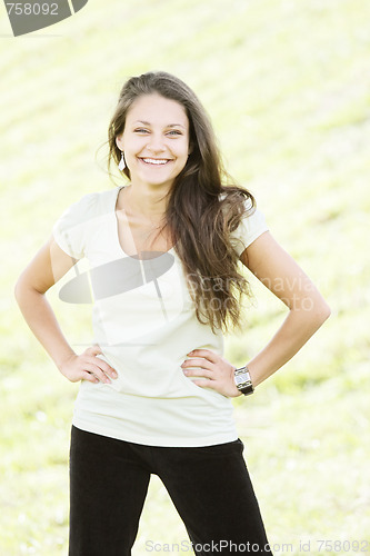 Image of Smiling brunette hands by sides