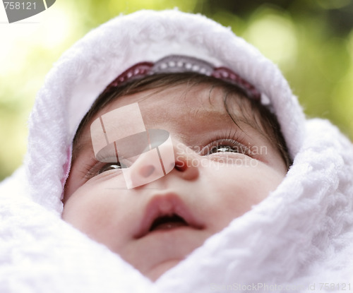 Image of Baby in coverlet looking up