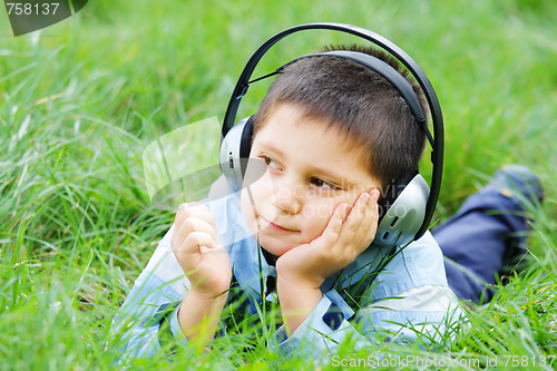 Image of Kid in grass with headphones