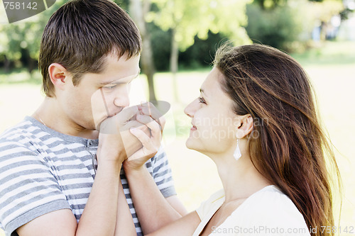 Image of Guy kissing girfriends hands
