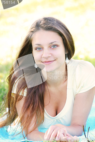 Image of Brunette laying on blue towel