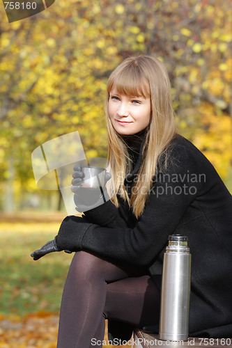 Image of Blonde holding cup