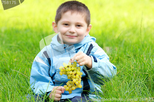 Image of Cute boy with grapes