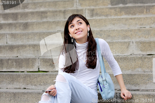 Image of Brunette enjoying music