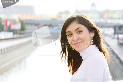 Image of Smiling girl at city river