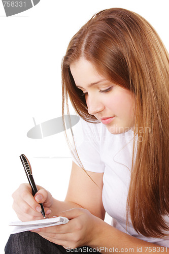 Image of Redhead makes notes sideview