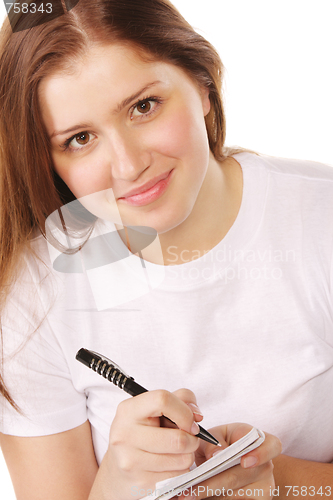 Image of Smiling redhead with notepad and pen