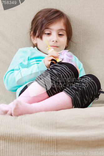 Image of Serene girl with doll