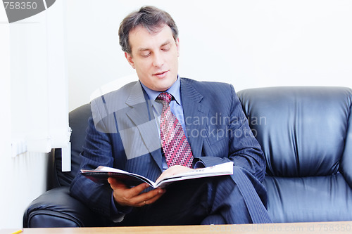 Image of Businessman reads magazine