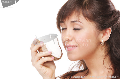 Image of Brunette smelling coconut