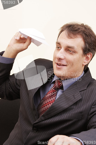 Image of Smiling businessman with paper plane