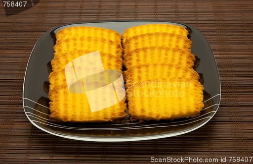 Image of plate of cookies on dark brown background