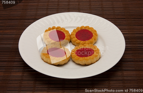Image of plate of cookies on dark brown background