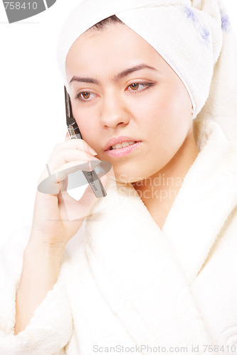Image of Woman in bathrobe talking on phone
